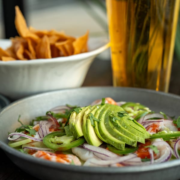 Sonora Mexican Kitchen's ceviche with shrimp, avocado, red onion, jalapeño, and cilantro, with chips and beer.
